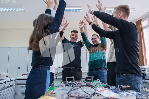 Image of students celebrating successfully finished project