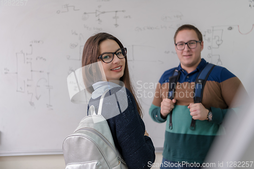 Image of portrait of young students in front of chalkboard