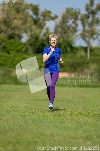 Image of young female runner training for marathon