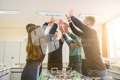 Image of students celebrating successfully finished project