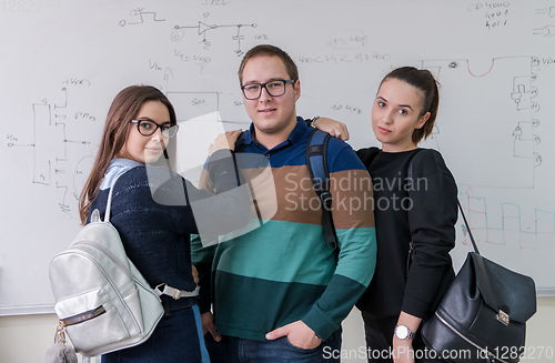 Image of portrait of young students in front of chalkboard