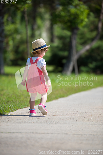 Image of little girl runing in the summer Park