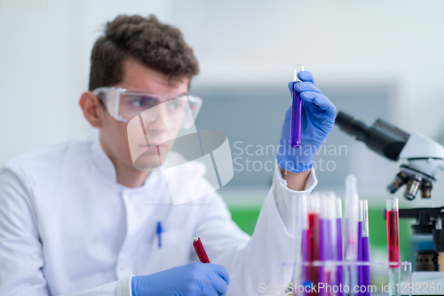 Image of student with protective glasses making chemistry experiment