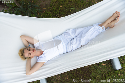 Image of young woman resting on hammock