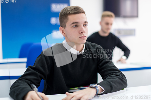 Image of male student writing notes