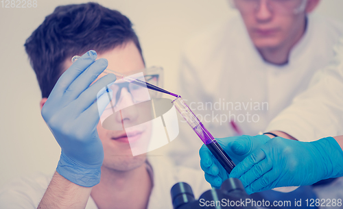 Image of student with protective glasses making chemistry experiment