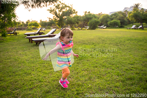 Image of little girl spending time at backyard