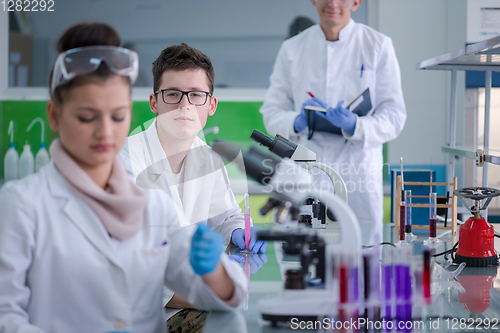 Image of Group of young medical students doing research