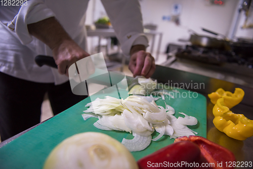 Image of Chef hands cutting fresh and delicious vegetables