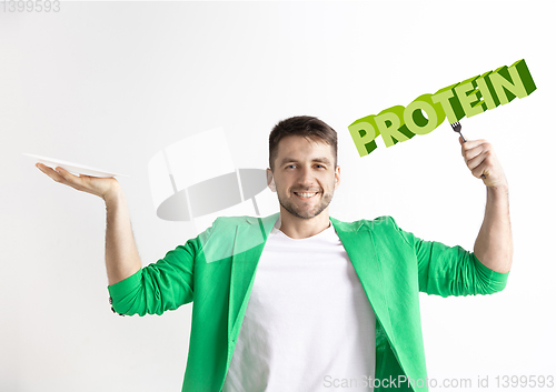 Image of Food concept. Model holding a plate with letters of Protein