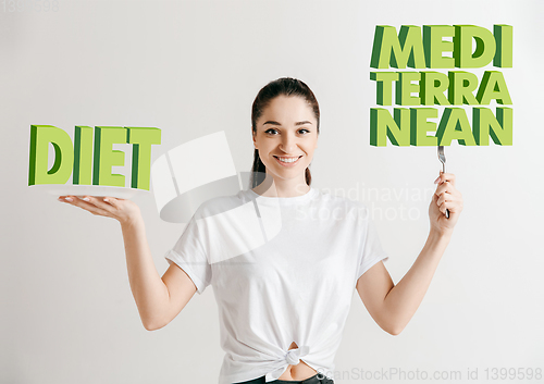 Image of Food concept. Model holding a plate with letters of Diet, Mediterranean