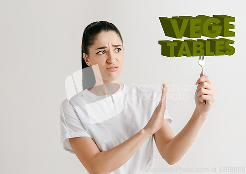 Image of Food concept. Model holding a plate with letters of Vegetable