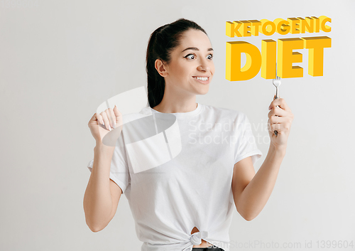 Image of Food concept. Model holding a plate with letters of Ketogenic Diet
