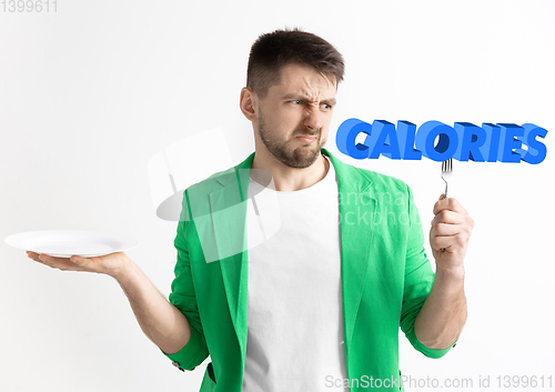 Image of Food concept. Model holding a plate with letters of Calories