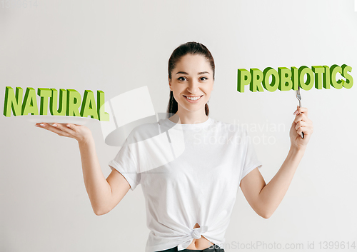 Image of Food concept. Model holding a plate with letters of Natural Probiotics