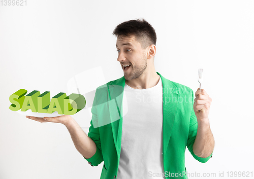 Image of Food concept. Model holding a plate with letters of Salad