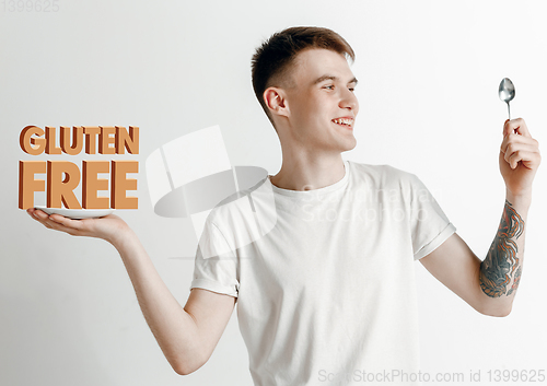Image of Food concept. Model holding a plate with letters of Gluten Free