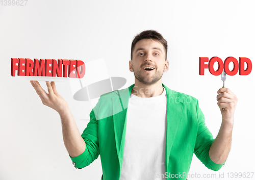 Image of Food concept. Model holding a plate with letters of Fermented Food