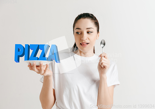 Image of Food concept. Model holding a plate with letters of Pizza