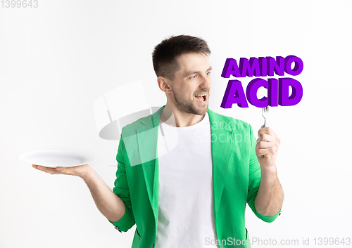 Image of Food concept. Model holding a plate with letters of Amino Acid