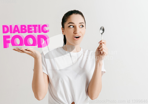 Image of Food concept. Model holding a plate with letters of Diabetic Food