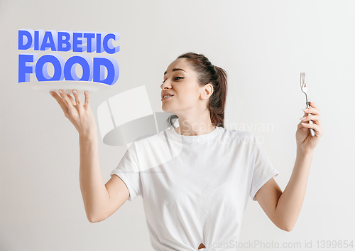 Image of Food concept. Model holding a plate with letters of Diabetic Food