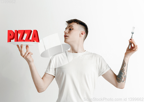 Image of Food concept. Model holding a plate with letters of Pizza