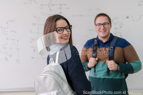 Image of portrait of young students in front of chalkboard