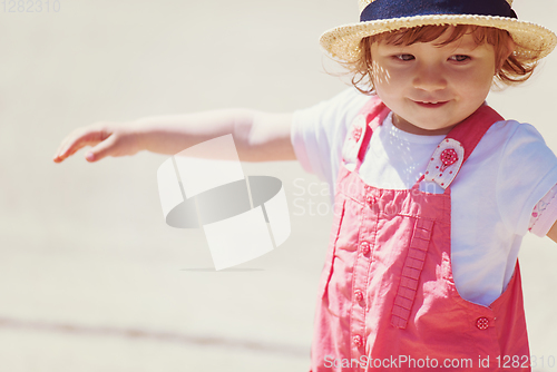 Image of little girl runing in the summer Park