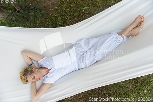 Image of young woman resting on hammock