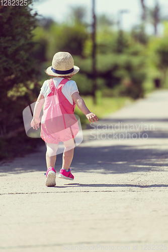 Image of little girl runing in the summer Park