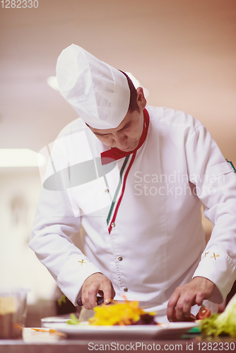 Image of chef serving vegetable salad