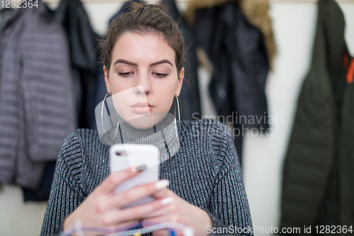 Image of female student using a mobile phone