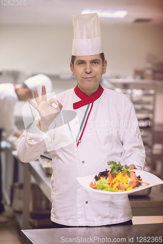 Image of Chef showing a plate of tasty meal