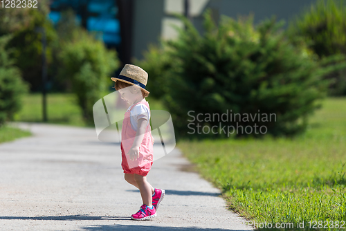 Image of little girl runing in the summer Park