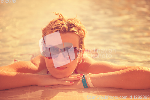 Image of woman enjoying holidays in the swimming pool