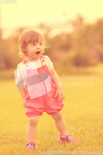 Image of little girl spending time at backyard