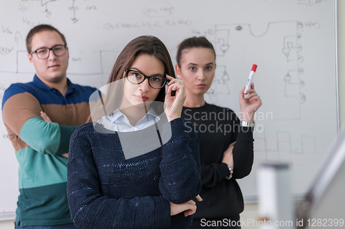 Image of portrait of young students in front of chalkboard