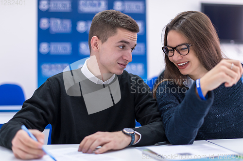 Image of young students writing notes