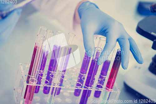 Image of student with protective glasses making chemistry experiment