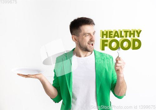 Image of Food concept. Model holding a plate with letters of Healthy Food