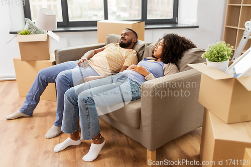 Image of couple with boxes tired after moving to new home