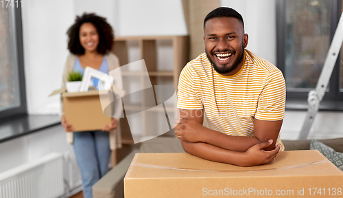 Image of happy couple with boxes moving to new home