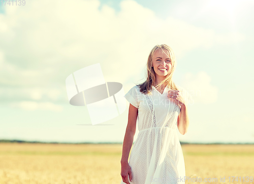 Image of happy young woman or teenage girl on cereal field