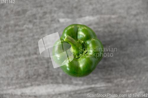 Image of close up of green pepper on slate stone background