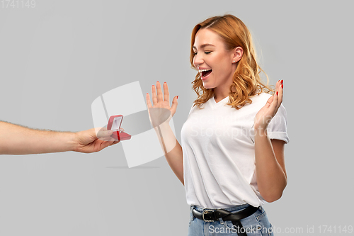 Image of man giving woman engagement ring on valentines day