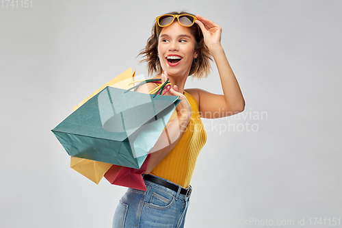 Image of happy smiling young woman with shopping bags