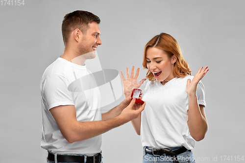 Image of man giving woman engagement ring on valentines day