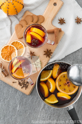 Image of pot with hot mulled wine, orange slices and spices