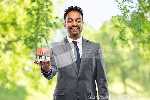 Image of indian man realtor with house model